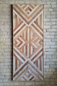 a wooden wall hanging on a brick wall