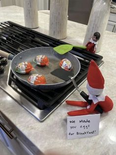 an elf frying marshmallows in a pan on top of the stove