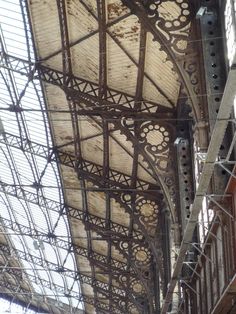 the inside of an old train station with exposed ceiling and metal scaffoldings