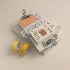 two rolls of yellow tape sitting next to each other on top of a white table