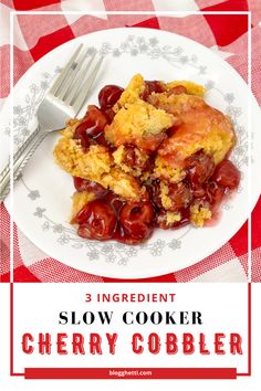 a white plate topped with cherry cobbler next to a red and white checkered table cloth