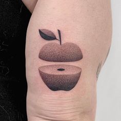 a woman's thigh with an apple tattoo on it