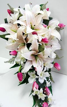 a bouquet of white and pink flowers on a table