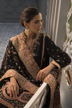 This handcrafted aari embroidered shirt features foliage and animals that are reminiscent of the mughal era. The pops of colour of threadwork and embellishment on the depth of black has stunning finesse. Paired with rawsilk trousers and an heirloom self jamawar aari shawl with worked borders, this piece is one that you Loose Shirt Dress, Loose Shirt, Pakistani Designers, Floral Tapestry, Organza Dupatta, Indian Clothes, Fabric Stores Online, Fashion Shoot, Designer Suits