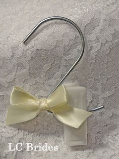 a close up of a metal hook with a bow tie on it's end