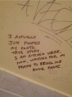 graffiti written on the wall in a bathroom