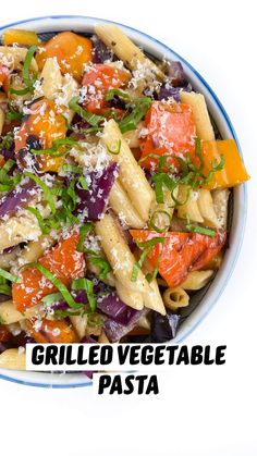 a bowl filled with pasta and vegetables covered in parmesan cheese on the side