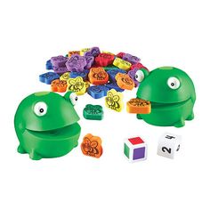 an assortment of colorful plastic toys with numbers and shapes on the front, including one frog