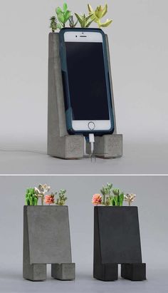 an iphone is plugged into a concrete planter with flowers in the bottom and on top