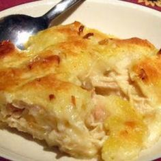 a close up of a plate of food on a table with a spoon and fork