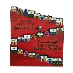 a wooden sign with houses on it that says, up on the housetop and down from