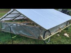 a small metal structure sitting in the grass