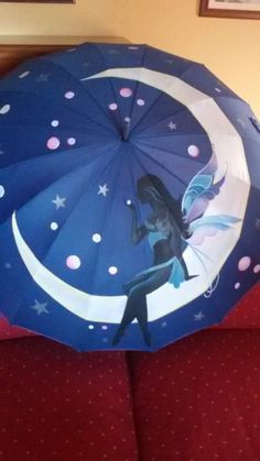 an open umbrella with a fairy on it