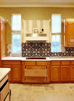 an empty kitchen with wooden cabinets and tile backsplashes on the wall,