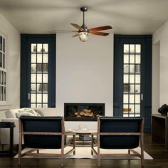 a living room filled with furniture and a fire place in front of two large windows