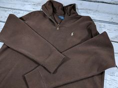 Polo Ralph Lauren Men's 1/4 Zip Long Sleeve Pullover Sweater. Embroidered tan logo pony on the left chest. Brown leather zipper pull. Zip through stand up collar.  Ribbed collar and hems.  100% Cotton. Size Large Excellent condition. No holes or stains.  Measurements (These are taken when items are laid flat. All measurements are within a 1/4."): Shoulder to bottom waist hem: 27" Armpit to bottom waist hem: 18" Shoulder to shoulder: 20"  Armpit to armpit: 22"   U.S. SELLER     PLEASE NOTE: This Brown Half-zip Top For Winter, Casual Brown Crew Neck Polo Sweater, Casual Brown Cotton Polo Sweater, Casual Brown Half-zip Top, Luxury Fitted Brown Polo Sweater, Brown Long Sleeve Polo Sweater, Polo Ralph Lauren Half Zip Sweater, Mens 1/4 Zip, Stand Up Collar