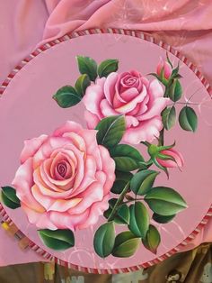 a pink plate with two roses painted on it