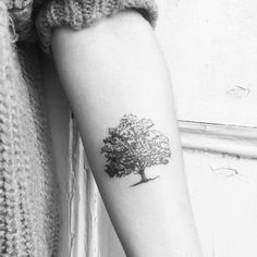 a small tree tattoo on the arm