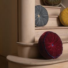 three round cushions sitting on the steps of a staircase