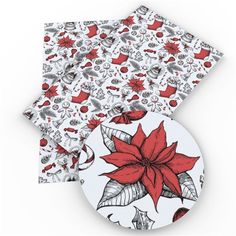 two coasters with poinsettia and leaves on them, one is red