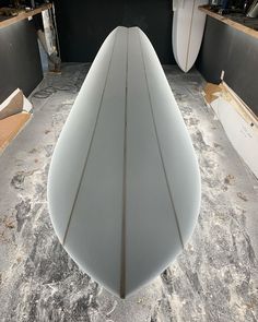 three surfboards are lined up in a storage area