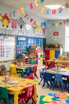 a classroom filled with lots of colorful desks and chairs next to a wall covered in happy birthday letters