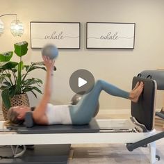 a man is doing exercises on an exercise machine with a ball in front of him