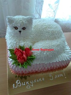 a cake shaped like a cat sitting on top of a table