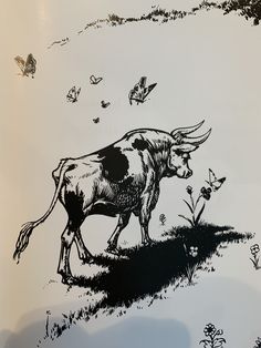 a black and white drawing of a cow walking in the grass with butterflies flying around