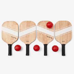 four paddles with red balls on them