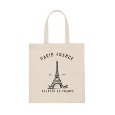 Voyager en France, "Travel in France"...  Float into a Parisian dream toting this lightweight canvas bag. This tote is the perfect gift for one who is getting ready to visit Paris or dreams of the romantic City of Lights. Coordinating items in this collection at etsy.com/shop/threeEmarket. Measuring at 15.75"h x 15.25"w and with a handle length of 21.5", these tote bags are with 100% cotton sheeting. Reinforced handle stitching make this a reliable bag rich in both practicality and durability. M Beige Canvas Bag With Letter Print For Travel, Eco-friendly Travel Bag With Letter Print, Eco-friendly Canvas Travel Bag With Dust Bag, Eco-friendly Travel Shoulder Bag With Letter Print, We’ll Always Have Paris, Paris Crewneck, Paris Tshirt, City Tote Bag, Paris Landmarks