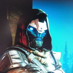 an image of a man in armor looking into the distance with blue lights on his face