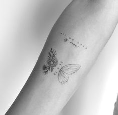 a black and white photo of a butterfly on the arm