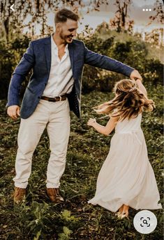 a father and daughter playing in the grass