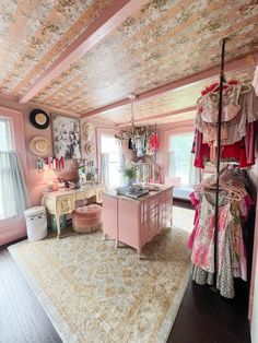 a room with pink walls and furniture in it