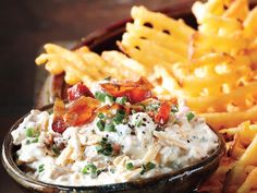 a bowl filled with fries and dip