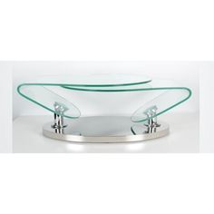 an oval glass table with two faucets on the top and one in the middle