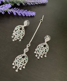 Make your self look pretty in these trendy White Rhodium finished earrings and matching tikka set! These earrings weigh about 0.4 Oz. The length of the tikka is shown in one of the pictures. Product care: Avoid contact with Chemicals such as Perfumes or any Sprays. Prevent the Jewellery from the water. Use Butter Paper or Cotton Cloth to store your Jewelry for a longer Product life. Silver Tikka With Matching Earrings, Elegant Silver Tikka With Matching Earrings, Silver Chandbali Tikka With Matching Earrings, Silver Tikka With Matching Earrings For Diwali, Chandbalis Earrings, Butter Paper, Jhumki Earrings, Indian Wedding Jewelry, Jhumka Earrings