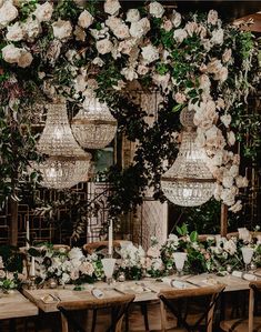 the table is set with white flowers and greenery for an elegant dinner party or wedding reception