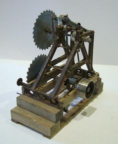 an old metal machine with wheels on it