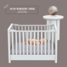 an image of a baby crib with a ball on the top and side rails