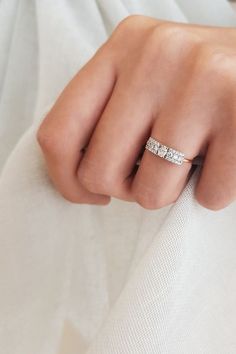 a woman's hand with a diamond ring on it