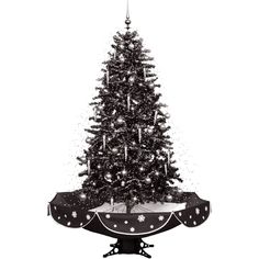 a black and white photo of a christmas tree with snow falling all over the top