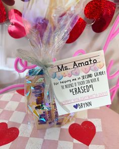 a candy bar wrapped in cellophane and tied with a bow on top of a table