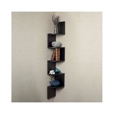 an image of a shelf that is on the wall with books and vases in it