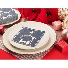 two plates with napkins on top of them and christmas decorations in the back ground