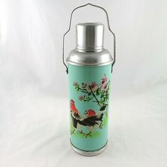 a metal canister with roosters painted on it