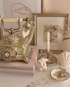 an antique phone sits on top of a table next to shells and seashells