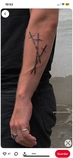 a man with a tattoo on his arm holding a knife in one hand and an arrow in the other