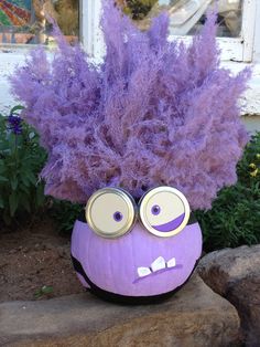 a purple plant with googly eyes on it